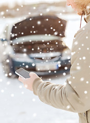 Image showing closeup of man with broken car and smartphone