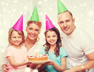 Image showing happy family with two kids in party hats at home