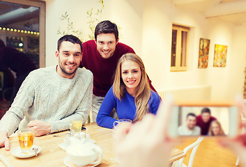 Image showing group of friends taking picture with smartphone