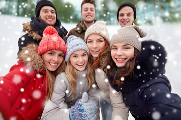 Image showing group of smiling friends taking selfie outdoors