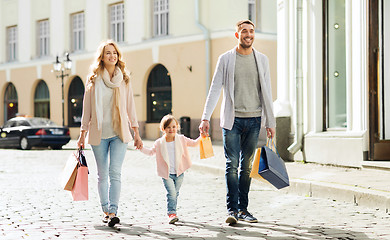 Image showing happy family with child and shopping bags in city