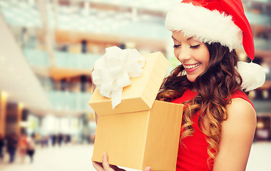 Image showing smiling woman in red dress with gift box