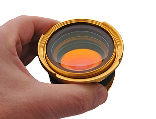 Image showing Gold lens in hand, isolated