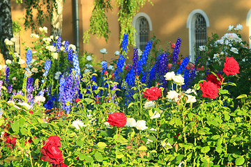 Image showing beautiful flowers on the bed