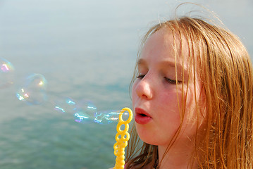 Image showing Girl blowing bubbles
