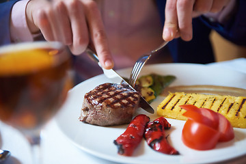 Image showing business man eating tasty beef stak