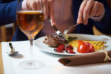 Image showing business man eating tasty beef stak