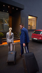 Image showing business people couple entering  hotel