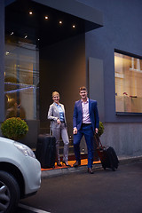 Image showing business people couple entering  hotel