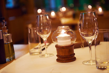 Image showing Wine bottles on a wooden shelf.