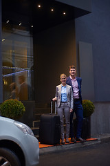 Image showing business people couple entering  hotel