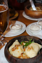 Image showing dumplings with bacon and sour cream in the restaurant