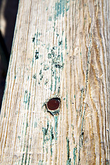 Image showing metal nail dirty stripped paint in green