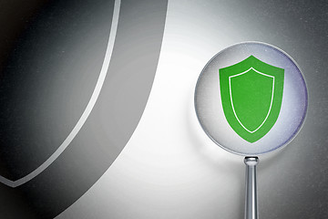 Image showing Security concept:  Shield with optical glass on digital background