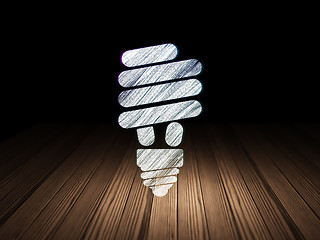 Image showing Finance concept: Energy Saving Lamp in grunge dark room
