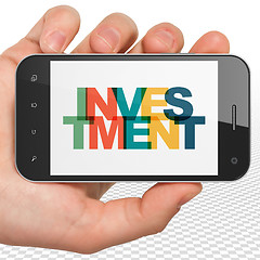 Image showing Finance concept: Hand Holding Smartphone with Investment on  display