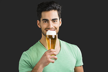 Image showing Young man drinking beer