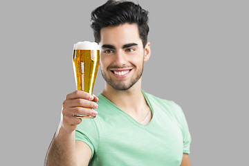 Image showing Young man drinking beer