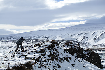 Image showing Photographer in wintry mountain landscape, Iceland