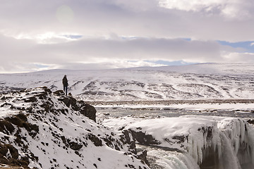 Image showing Hiker at mountain top of waterfall Godafoss