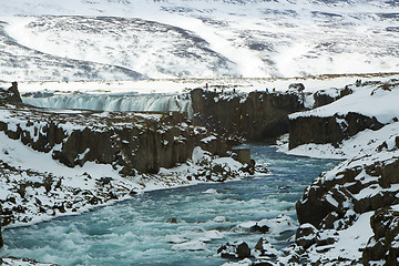 Image showing Tourists at the Icelandic waterfall Godafoss in wintertime