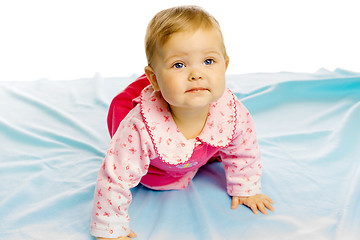 Image showing baby girl in a dress crawling