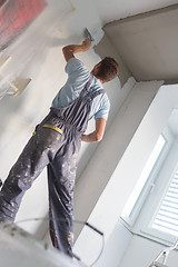 Image showing Plasterer renovating indoor walls and ceilings.