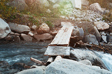 Image showing Wooden bridge over small river