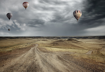 Image showing Air balloons over the country road