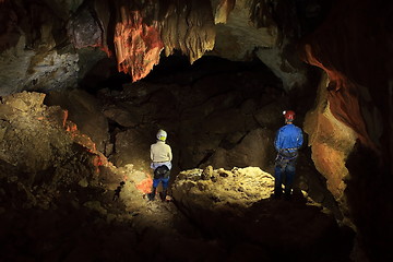 Image showing speleologists in lightened cave