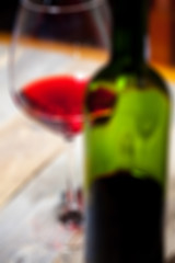 Image showing red wine in glass and green bottle