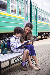 Image showing beautiful woman and boy waiting train