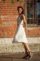 Image showing beautiful middle-aged woman in a white dress