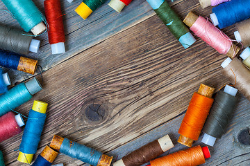 Image showing Vintage spools with multi colored threads