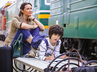 Image showing Mother and son waiting for a train