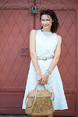Image showing Smiling beautiful middle-aged woman in a white dress
