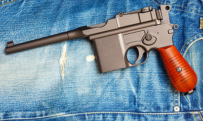 Image showing Mauser submachine gun on vintage jeans