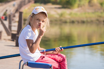 Image showing Girl fishing calls for silence