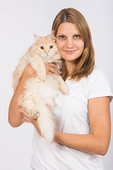 Image showing Girl hugging domestic cat