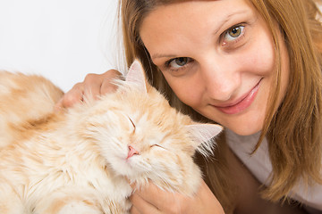 Image showing She caresses his domestic cat