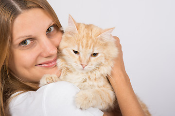 Image showing Girl hugging a disgruntled cat