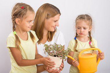 Image showing One daughter was mad at my mom and another daughter watering flowers