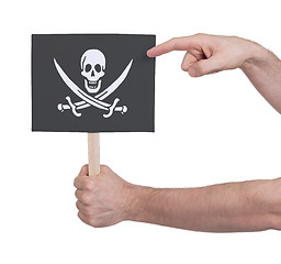 Image showing Hand holding small card - Flag of Pirate