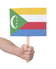 Image showing Hand holding small card - Flag of Comoros