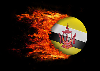 Image showing Flag with a trail of fire - Brunei