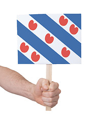 Image showing Hand holding small card - Flag of Friesland