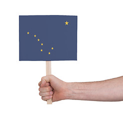 Image showing Hand holding small card - Flag of Alaska