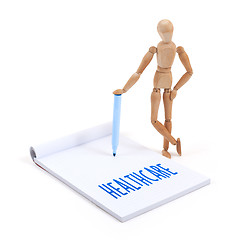 Image showing Wooden mannequin writing - Healthcare