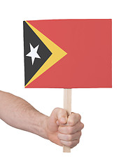 Image showing Hand holding small card - Flag of East Timor