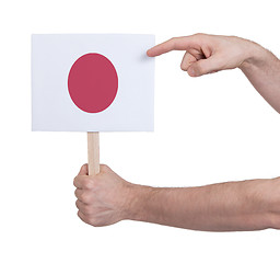 Image showing Hand holding small card - Flag of Japan